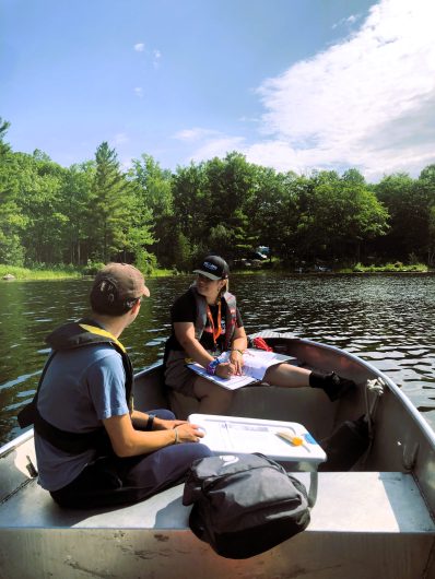 Andrea and Thomas, Shoreline Assessment Technicians, assess shoreline properties on Six Mile Lake for the Love Your Lake program.