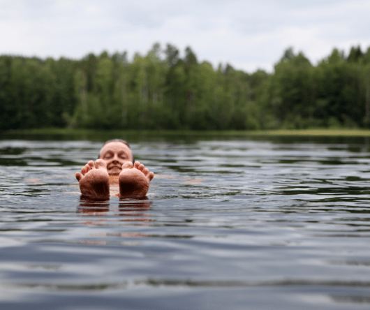 Photo of a man floating in a lake