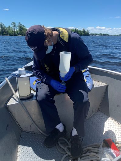 Photo of a Water Quality Technician collecting water samples to phosphorus analysis