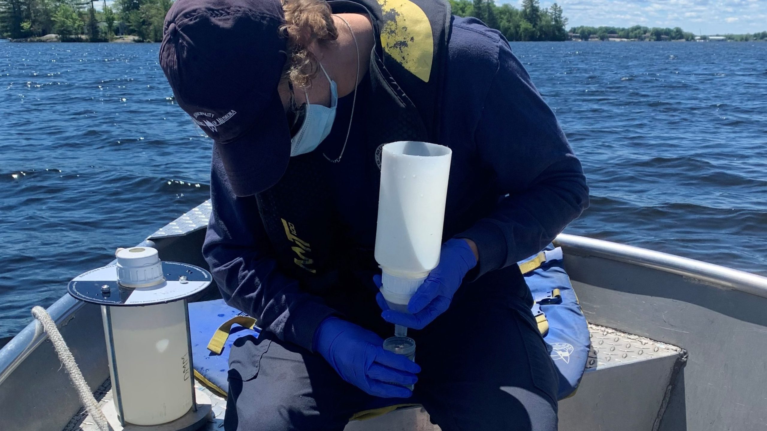 Photo of a Water Quality Technician collecting water samples to phosphorus analysis