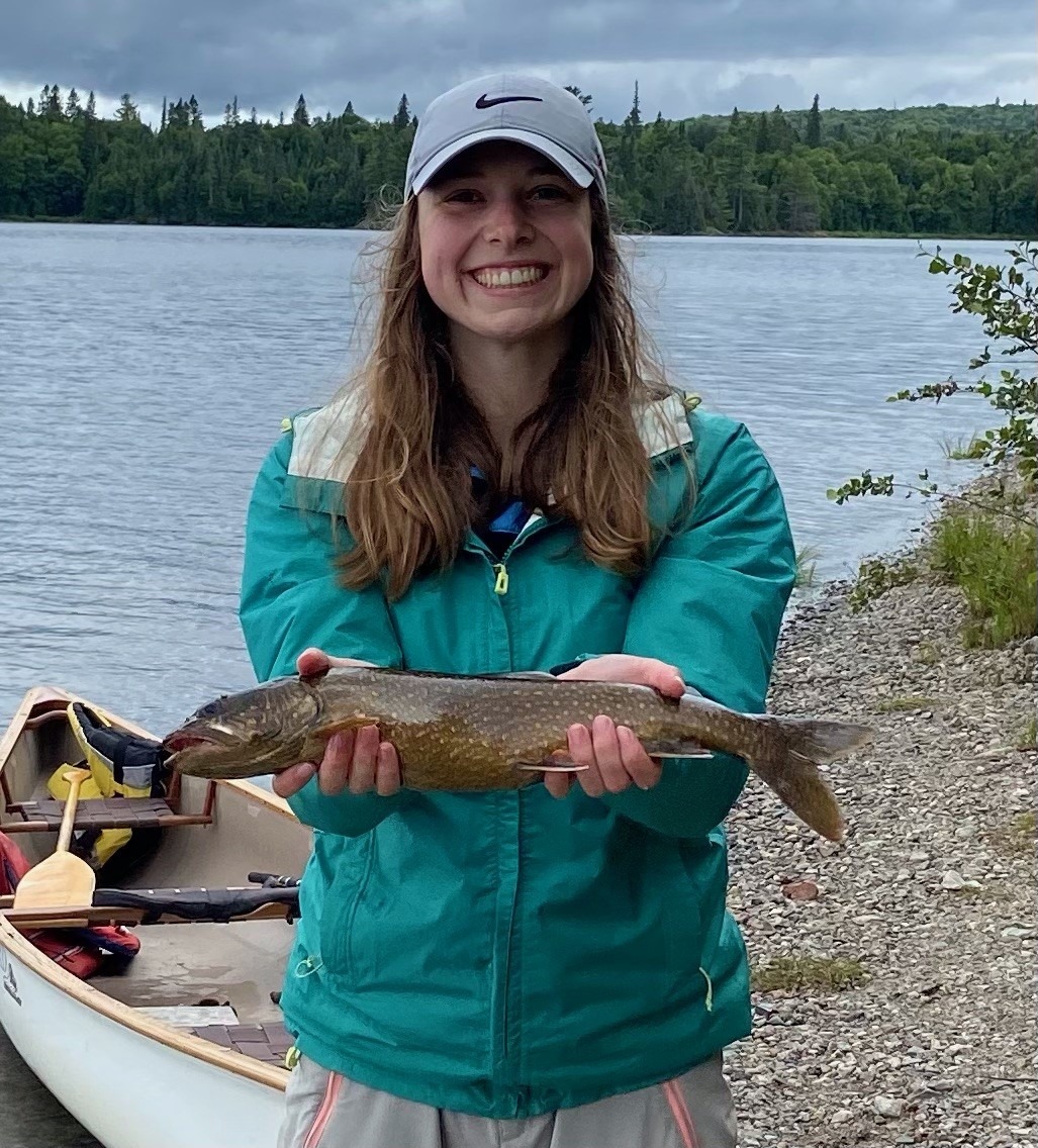 Photo of a woman holding a Lake trout.